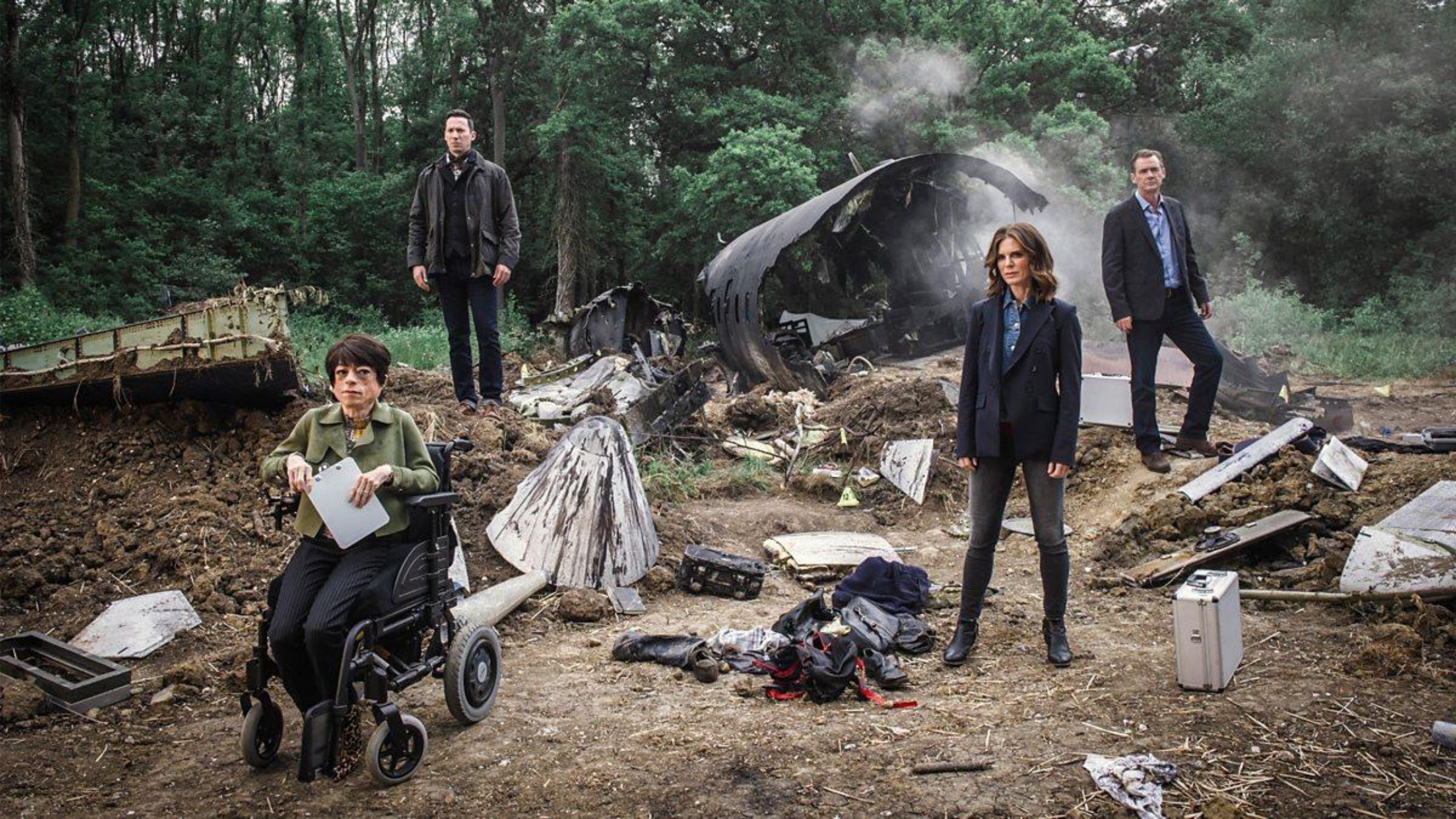 Cast of Silent Witness stand by a plane wreckage