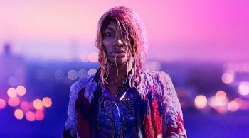Michaela Cole in I May Destroy You, stood with wet hair against the London skyline at dawn