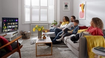 Family sitting on a sofa watching TV